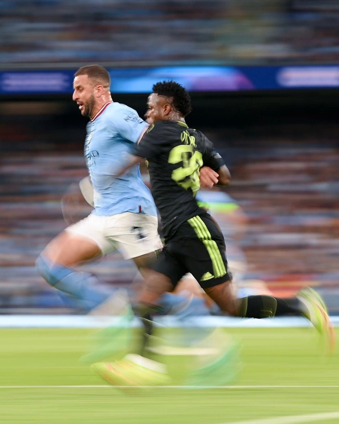 Kyle Walker of Manchester City and Vinícius Júnior of Real Madrid sprint shoulder to shoulder